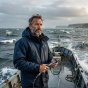 Portrait of physical oceanographer Henrik Vangen aboard a coastal vessel
